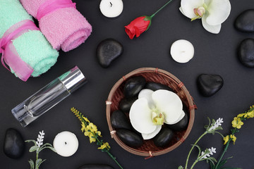 Obraz na płótnie Canvas Spa and aromatherapy concept on black background. Zen stones, accessories used in aromatherapy. Flat lay. Top view.