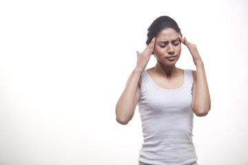 Fototapeta premium Woman suffering from headache isolated over white background 