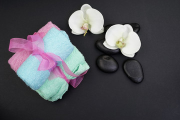 Spa and aromatherapy concept on black background. Zen stones, accessories used in aromatherapy. Flat lay. Top view.