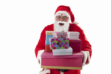 Portrait of surprised Santa Claus with Christmas presents over white background 
