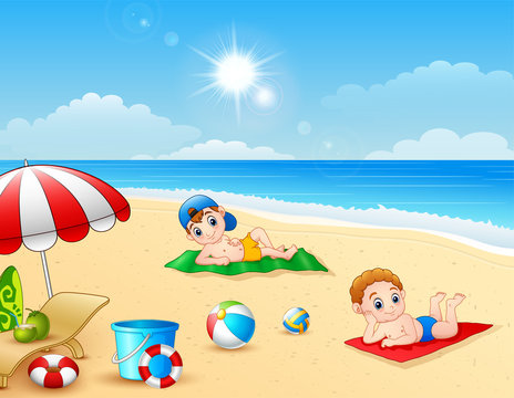 Two boy sunbathing on the beach mat