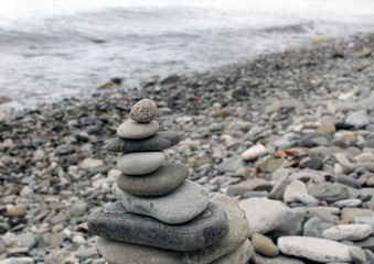 Fototapeta na wymiar Tower from stones about seaside