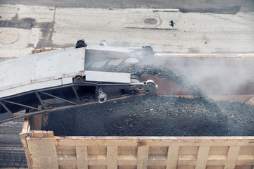 Road works. Asphalt removing machine loading powdered asphalt on the truck © malkovkosta