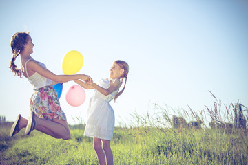 Happy little children playing in the field at the day time.