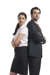 Portrait of business colleagues standing arms crossed over white background