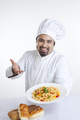 Portrait of chef with plate of pasta