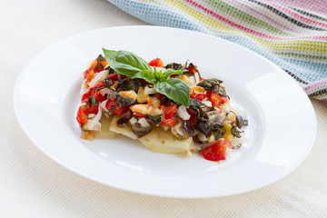 Oven roasted vegetables with cheese on white plate