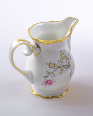 An old German empty faience mug for cream.