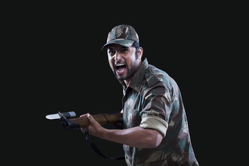 Angry soldier holding gun 