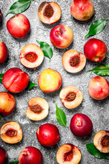 Fresh peaches with green leaves.