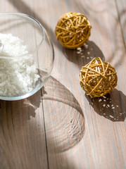 Sea salt in glass ball on wooden table