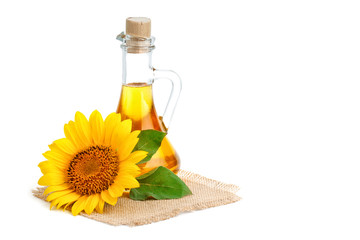 Beautiful sunflowers and sunflower oil on a white background.