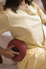 Fototapeta premium Woman applying a hot water bag 