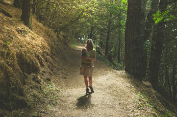 Obraz premium Mother with baby in forest clearing
