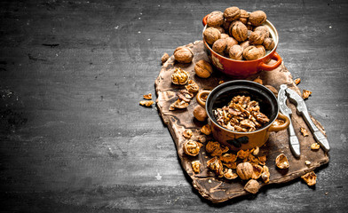 Shelled walnuts in bowl with Nutcracker.