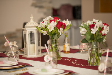 Burgundy and white table set. Birthday and anniversary dinner. Celebration