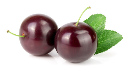 Purple plum with leaves isolated on white background
