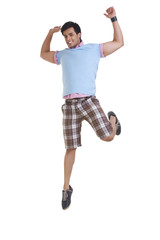 Full length of young man in casuals jumping isolated over white background