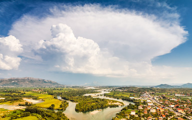 Valley with river and mountain background under blue sky with unusual cloud, Albania - Europe.
