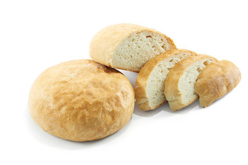 Fresh fragrant white bread with slices isolated on white.