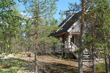 Fototapeta na wymiar Wooden hut in the finnish forest