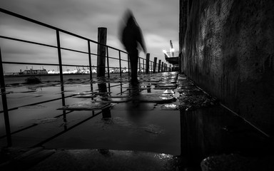 Man walking at the pier near the harbor