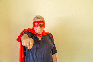 senior superhero pointing