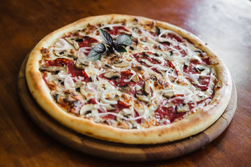 delicious pizza with meat, cheese and mushrooms