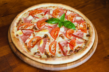 delicious pizza with meat, cheese and mushrooms