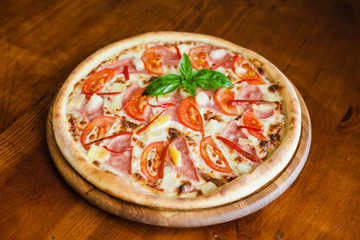 delicious pizza with meat, cheese and mushrooms