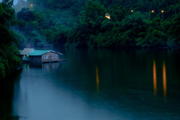 Mountain forest with fog and houseboat on kwai river landscape on rain in kanchanaburi, Thailand. Natural concept