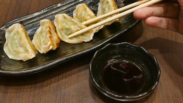 Japanese dumpling, Deep fried Gyoza eating with Shouzu with chopsticks