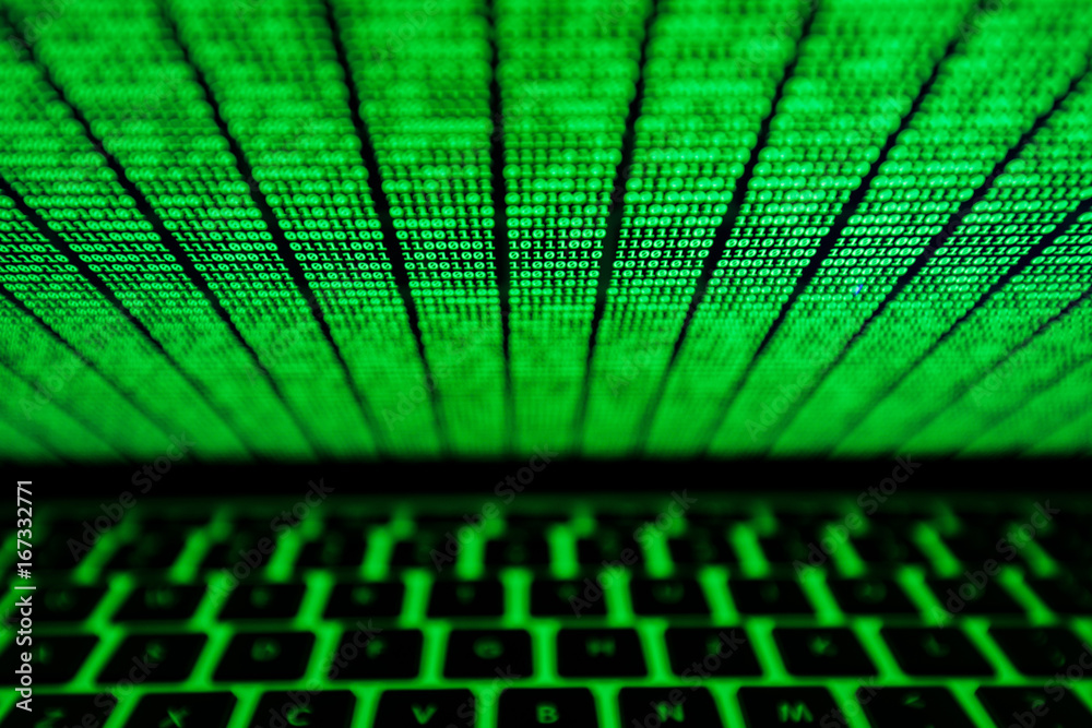 Wall mural screen of laptop with green binary code glowing in the dark