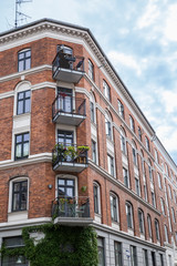 Fototapeta na wymiar Facade of red brick Building with Balconies, Copenhagen, Europe