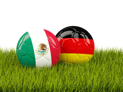 Mexico and Germany soccer balls on grass
