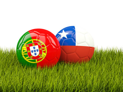 Portugal and Chile soccer balls on grass