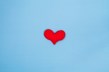 Fototapeta na wymiar Red heart on blue background from top view with space for copy. Valentines day concept.