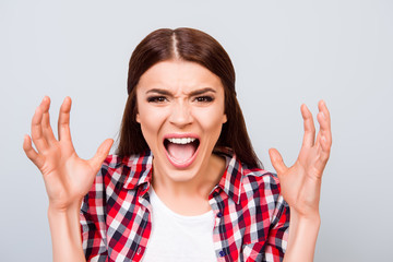 Going crazy and insane. Close up portrait of shouting stressed young girl, ready to attack, on pure...