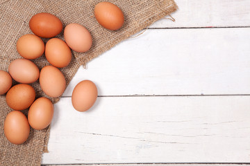 Chicken egg on wood table on sack with space for copy.