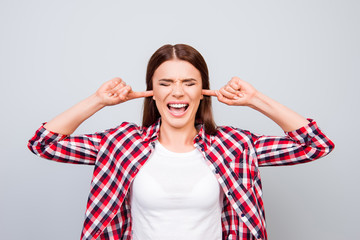 Stop it! Silence! Quiet! Close up of a stressed yelling teen with closed eyes and ears. She is in a...