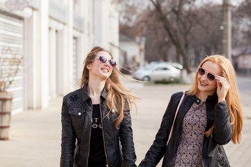 Two girl friends hanging out outside in the city. Youth and friendship