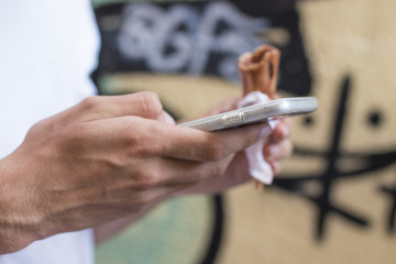 hands with the mobile phone on the street