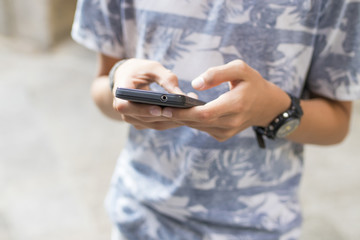 hands with the mobile phone on the street