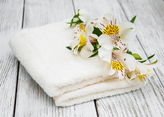 Fototapeta na wymiar Spa towels and alstroemeria flowers