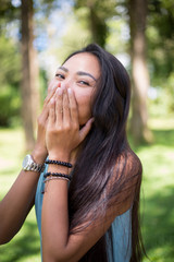 Young girl laughing and covering her mouth 