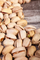 Delicious Pistachios on wooden background in studio photo. Healthy delicious snacks