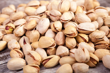 Close up of Pistachios on wooden background in studio photo. Healthy delicious snacks