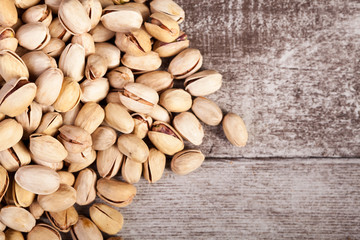 Pistachios on wooden background in studio photo with copyspace available. Healthy delicious snacks