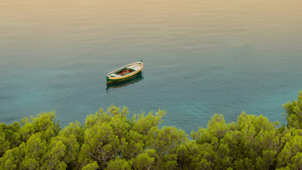 Small wooden boat on calm sea