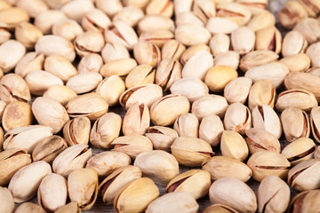 Over top close up view of Pistachios on wooden background in studio photo. Healthy delicious snacks